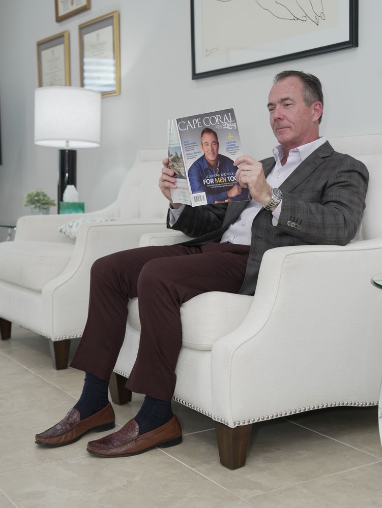 Dr. Prendiville reading Cape Coral Living in the practice
