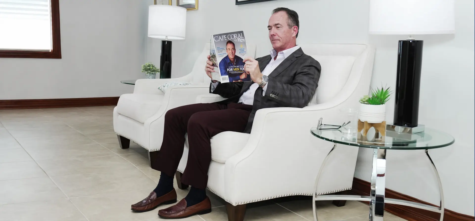 Dr. Stephen Prendiville seated in the practice reading Cape Coral Living